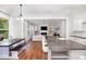 Modern kitchen with an island featuring seating, granite countertops, and open view to the living space at 1502 Spring Overlook Ln, Hillsborough, NC 27278