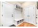 Well-organized mudroom entry with built-in storage, a bench, and hooks, providing functionality and style at 1502 Spring Overlook Ln, Hillsborough, NC 27278