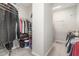 Organized walk-in closet with racks, shelves, and rods for efficient storage and clothing management at 1502 Spring Overlook Ln, Hillsborough, NC 27278