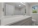 Modern bathroom featuring a gray vanity with white countertop and framed mirror at 1524 Wedgewood Dr, Graham, NC 27253