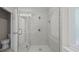 Modern bathroom features glass shower with gray tile surround and hexagon tile flooring at 1524 Wedgewood Dr, Graham, NC 27253