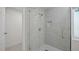 Modern bathroom features glass shower with gray tile surround and hexagon tile flooring at 1524 Wedgewood Dr, Graham, NC 27253