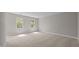 Bright bedroom with two windows allowing for lots of natural light, and neutral carpeting at 1524 Wedgewood Dr, Graham, NC 27253