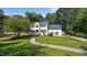 Charming two-story home with a manicured lawn, mature trees, and inviting front entrance at 1524 Wedgewood Dr, Graham, NC 27253
