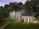 Charming two-story home with a manicured lawn, mature trees, and inviting front entrance at 1524 Wedgewood Dr, Graham, NC 27253