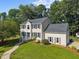 Charming two-story home with a manicured lawn, mature trees, and inviting front entrance at 1524 Wedgewood Dr, Graham, NC 27253