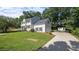 Two-story home showing the lawn and garage, with mature trees behind at 1524 Wedgewood Dr, Graham, NC 27253