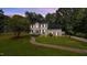 Charming two-story home with a manicured lawn, mature trees, and inviting front entrance at 1524 Wedgewood Dr, Graham, NC 27253