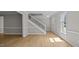 Bright foyer with wood floors, white trim, and a staircase, creating a welcoming entrance at 1524 Wedgewood Dr, Graham, NC 27253