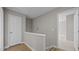 Bright hallway with hardwood floors, leading to bedrooms and storage spaces at 1524 Wedgewood Dr, Graham, NC 27253
