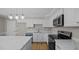 Updated kitchen featuring stainless steel appliances, granite counters and white cabinets at 1524 Wedgewood Dr, Graham, NC 27253