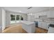 Bright kitchen features white cabinets, stainless steel appliances, and a center island with white countertop at 1524 Wedgewood Dr, Graham, NC 27253
