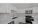 Updated kitchen featuring stainless steel appliances, granite counters and white cabinets at 1524 Wedgewood Dr, Graham, NC 27253