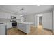 Bright, modern kitchen with white cabinets, stainless steel appliances, and a center island at 1524 Wedgewood Dr, Graham, NC 27253
