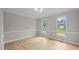 Light-filled living room with wood floors and crown molding at 1524 Wedgewood Dr, Graham, NC 27253