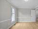Living room with wood floors, crown molding, base boards and large windows at 1524 Wedgewood Dr, Graham, NC 27253