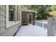 A beautiful screened in porch with white railings and wooden flooring at 1524 Wedgewood Dr, Graham, NC 27253