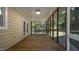 Enclosed outdoor wooden porch with screen panels and sliding glass door at 1524 Wedgewood Dr, Graham, NC 27253