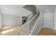 Inviting staircase with carpeted steps, elegant railings, and light wood flooring at 1524 Wedgewood Dr, Graham, NC 27253