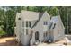 New construction home featuring a light gray brick exterior, arched entryway, and grand windows at 1529 Lake Adventure Ct, Raleigh, NC 27613