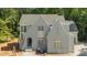 Newly constructed home with light gray brick, a gabled roof, and lots of natural light at 1529 Lake Adventure Ct, Raleigh, NC 27613