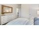 Light and airy bedroom featuring a large dresser and comfortable bedding at 165 Babbling Creek Dr, Youngsville, NC 27596