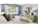 Inviting bedroom with a large window, a stylish dresser, and comfortable seating at 165 Babbling Creek Dr, Youngsville, NC 27596