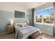 Cozy bedroom featuring a large window, neutral carpet, stylish decor, and a soothing two-tone paint scheme at 165 Babbling Creek Dr, Youngsville, NC 27596