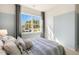 Comfortable bedroom with a window, neutral carpet, and a soothing two-tone paint scheme at 165 Babbling Creek Dr, Youngsville, NC 27596
