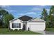 Charming one-story home with white siding, black accents, manicured lawn, and an attached two-car garage at 165 Babbling Creek Dr, Youngsville, NC 27596