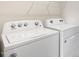 A bright laundry room featuring a Whirlpool washer and dryer appliances at 165 Babbling Creek Dr, Youngsville, NC 27596