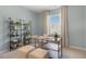 Bright office space with a window view, a contemporary desk, shelving, stylish decor, and neutral-toned carpet at 165 Babbling Creek Dr, Youngsville, NC 27596