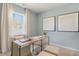 Comfortable office featuring natural light, a modern desk, ottomans, neutral-toned carpet, and soothing wall color at 165 Babbling Creek Dr, Youngsville, NC 27596