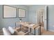 Well-appointed office with calming wall color, a desk, a chair, and an open doorway leading to other rooms at 165 Babbling Creek Dr, Youngsville, NC 27596