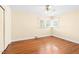 Bright bedroom features hardwood floors and a ceiling fan at 1702 Pinecrest St, Burlington, NC 27215