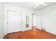 This bedroom boasts hardwood floors, ample closet space, and neutral paint at 1702 Pinecrest St, Burlington, NC 27215