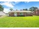 Charming single-story brick home with a well-manicured front lawn and classic design at 1702 Pinecrest St, Burlington, NC 27215