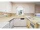 Traditional kitchen features light colored appliances and cabinetry at 1702 Pinecrest St, Burlington, NC 27215