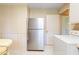 The eat in kitchen has a newer refrigerator and access to a laundry room at 1702 Pinecrest St, Burlington, NC 27215