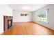 Bright living room with a brick fireplace and hardwood flooring at 1702 Pinecrest St, Burlington, NC 27215