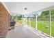 Relaxing screened porch with brick accents and an outdoor view of the backyard at 1702 Pinecrest St, Burlington, NC 27215