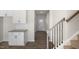 Inviting hallway featuring wood floors, leading to the front door and adjacent to the kitchen at 195 Babbling Creek Dr, Youngsville, NC 27596