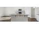 Modern kitchen with granite island, stainless appliances, and white cabinets, featuring sleek and contemporary design at 195 Babbling Creek Dr, Youngsville, NC 27596