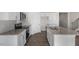 Well-equipped kitchen with a granite island, stainless appliances, and white cabinets for culinary enthusiasts at 195 Babbling Creek Dr, Youngsville, NC 27596