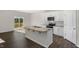 Modern kitchen with a granite island, stainless appliances, sliding doors to a deck, and ample cabinetry at 195 Babbling Creek Dr, Youngsville, NC 27596