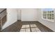 Bright living room with hardwood floors, natural light, and a staircase visible to the left at 195 Babbling Creek Dr, Youngsville, NC 27596