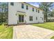 Backyard patio and grass, featuring a clean exterior, tidy landscaping, and multiple windows offering abundant natural light at 201 S Ennis St, Fuquay Varina, NC 27526