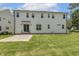 Backyard features manicured lawn, paved patio, and a bright exterior with multiple windows for ample natural light at 201 S Ennis St, Fuquay Varina, NC 27526