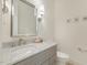 Elegant half bathroom featuring a marble countertop, decorative mirror, and stylish sconces at 201 S Ennis St, Fuquay Varina, NC 27526