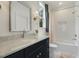 Bathroom with modern vanity, marble countertop, tub and shower, creating a relaxing and functional space at 201 S Ennis St, Fuquay Varina, NC 27526